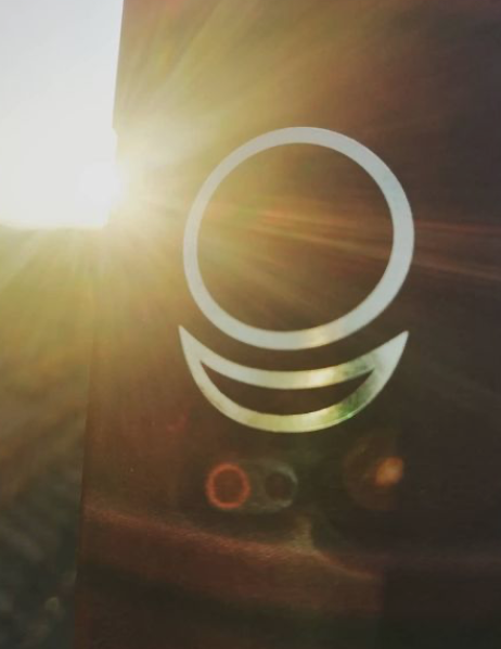 The Allatra symbol lit by low sun